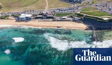 Man charged with displaying Nazi hate symbol after showing off tattoos at NSW beach