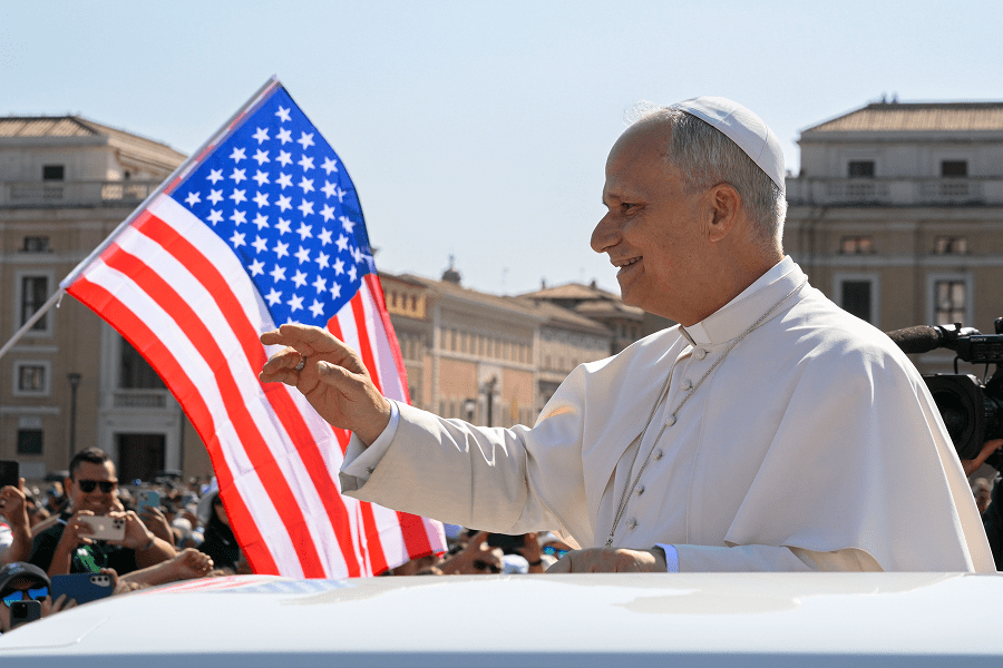 Pope Leo XIV waves to the crowd from the popemobile
