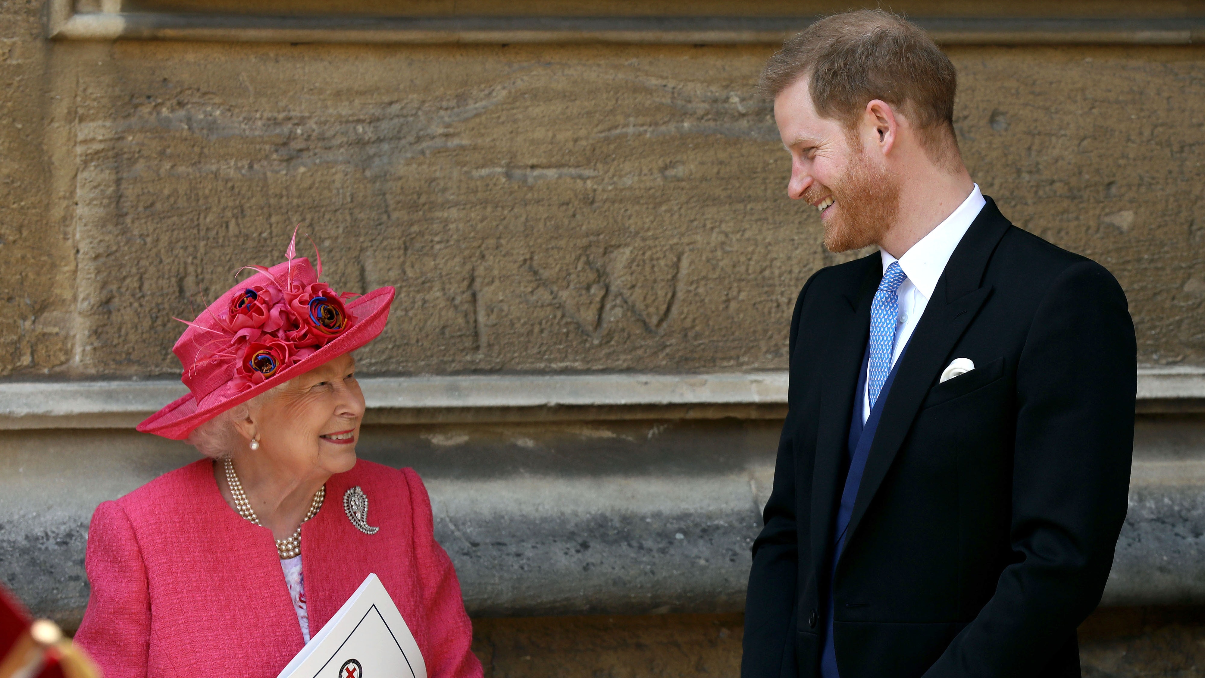 Queen Elizabeth II speaks with Prince Harry, Duke of Sussex as they leave after the wedding of Lady Gabriella Windsor to Thomas Kingston at St George's Chapel, Windsor Castle on May 18, 2019