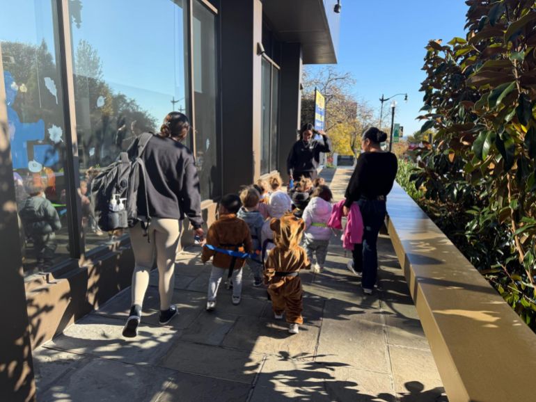 Kids walk along a Washington, DC, sidewalk outside CommuniKids