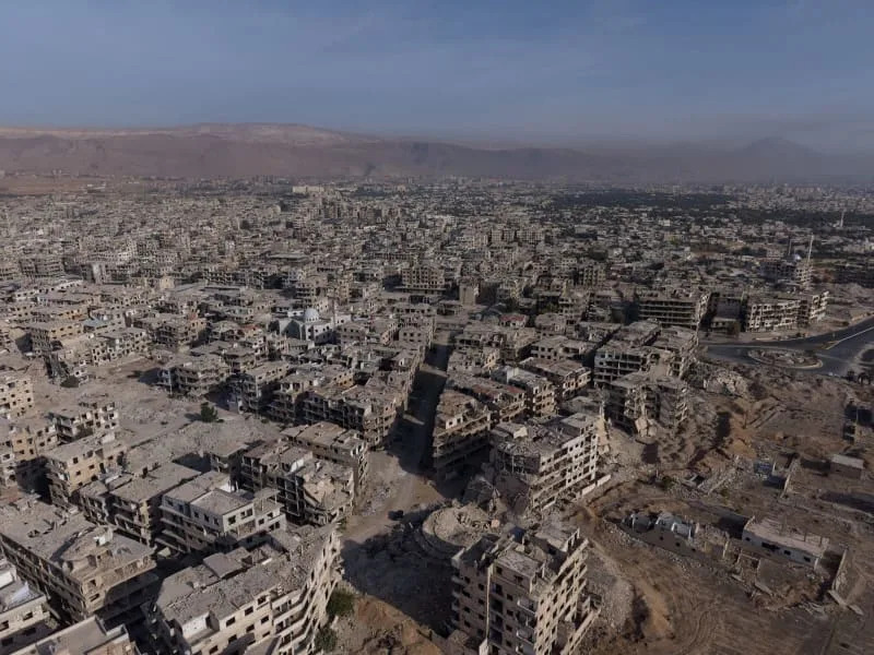 An aerial view shows the destruction to the city of Harasta, resulting in widespread poverty, damage to infrastructure and a collapse of services. Moawia Atrash/dpa