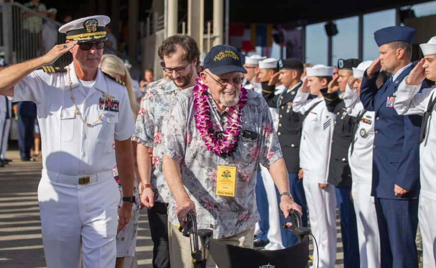 Ira Schab is saluted by members of the armed forces as he leaves the 75th Anniversary National Pearl Harbor Remembrance Day Commemoration on Wednesday, December 7, 2016, in Honolulu.