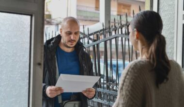Postman delivering letter to female person at the door - Representative Cover Image Source: Getty Images | Photo by 	Aleksandar Georgiev