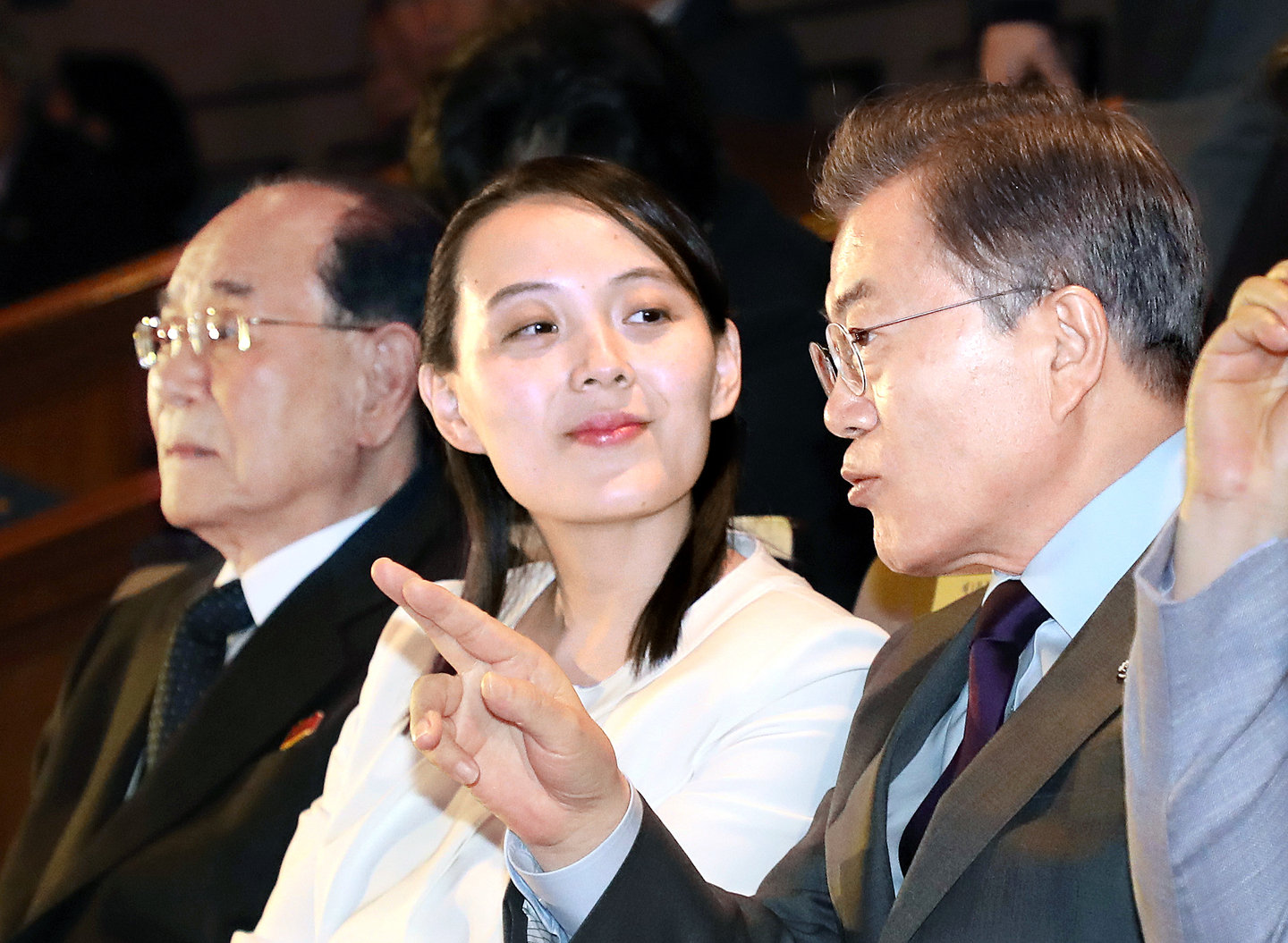 Former President Moon Jae-in talks with North Korea's leader Kim Jong-un's younger sister Kim Yo-jong during a performance by North's Samjiyon Orchestra at the National Theater of Korea in Seoul in February 2018. [YONHAP]