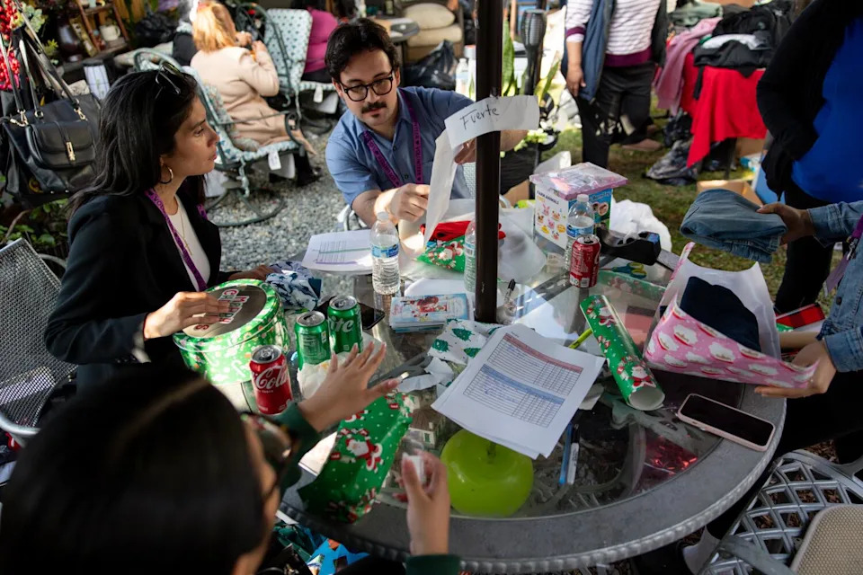 Volunteers put together a gift bag for an immigrant family during an angel tree event in Maywood.