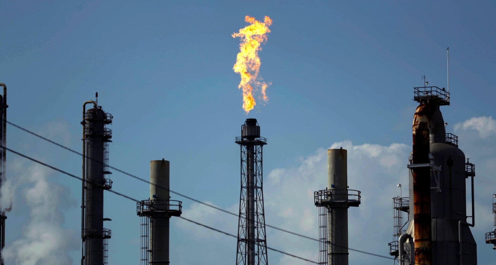 A flame burns at an oil refinery