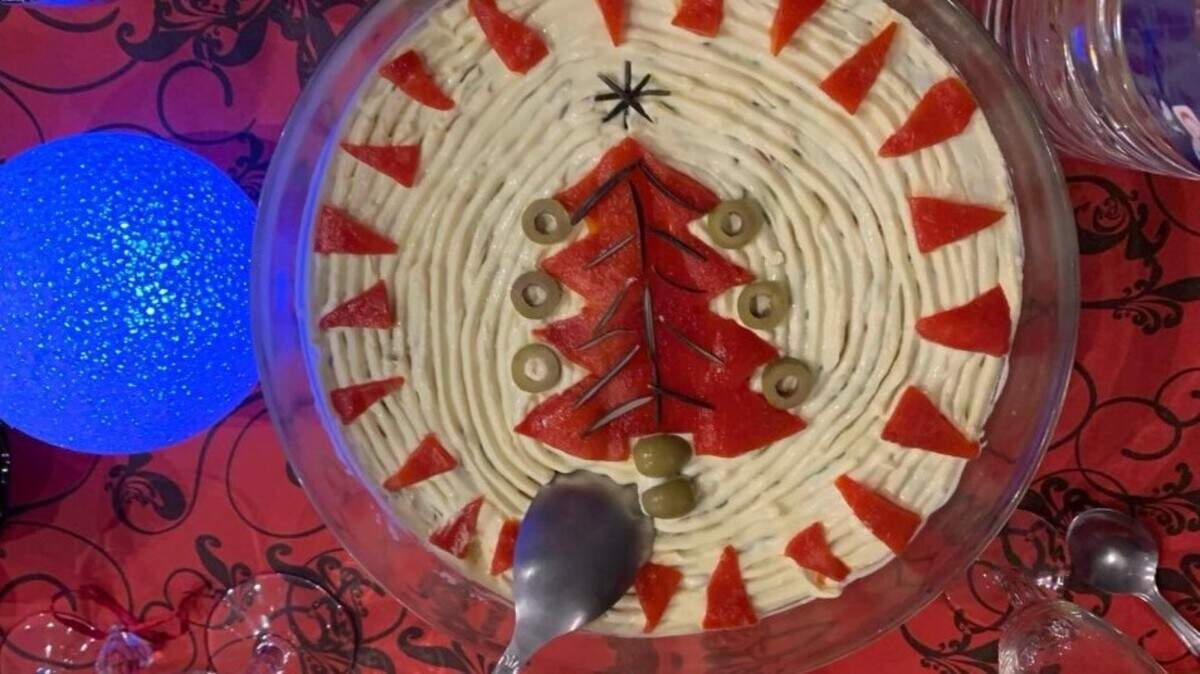 Potatoes, carrots, peas, and pickled cucumber, and the option to add beef or chicken, mixed with homemade mayonnaise, decorated festively