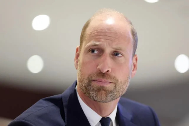 The Prince of Wales listens to a speaker during a visit to Cardiff