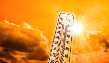 A thermometer stands against an orange sky and glowing sun during a heatwave, illustrating rising temperatures linked to climate change. (Adobe Stock Photo)