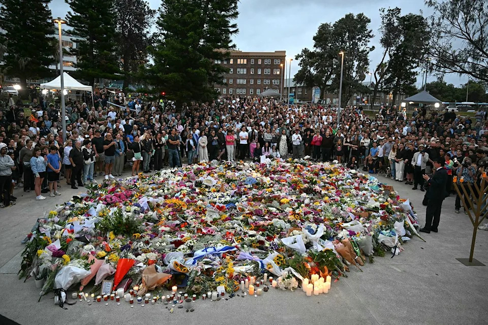 Saeed KHAN / AFP via Getty Mourners gather at a tribute at the Bondi Pavillion in memory of the victims of a shooting at Bondi Beach, in Sydney on Dec. 15, 2025.