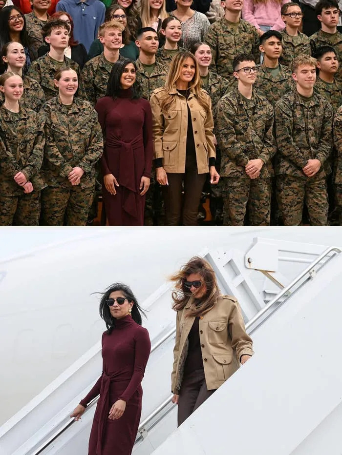 A group photo with people in military uniforms; usha and melania in the front are dressed in a tan jacket and a burgundy dress