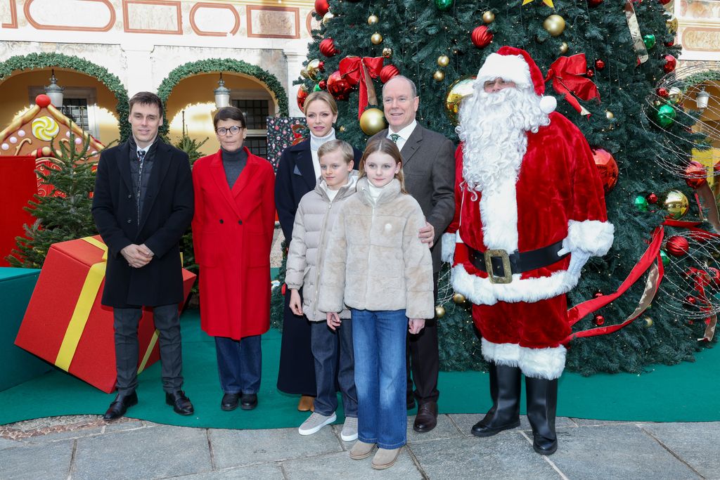 Princess Gabriella with parents and brother beside santa and christmas tree