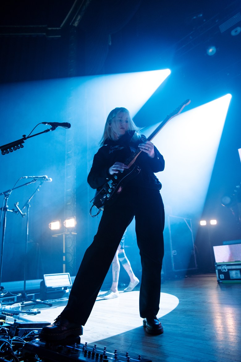 Zoe Manville plays bass on stage. 