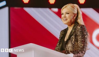 Erika Kirk enters the stage for Turning Point's America Fest conference in Phoenix, Arizona