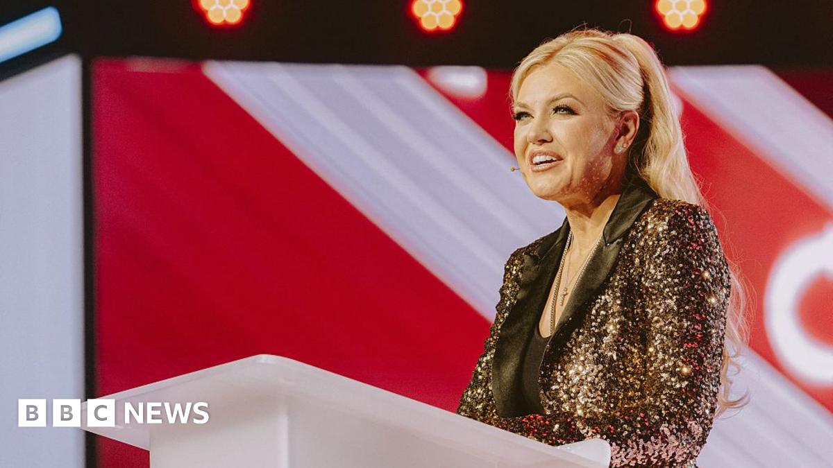 Erika Kirk enters the stage for Turning Point's America Fest conference in Phoenix, Arizona