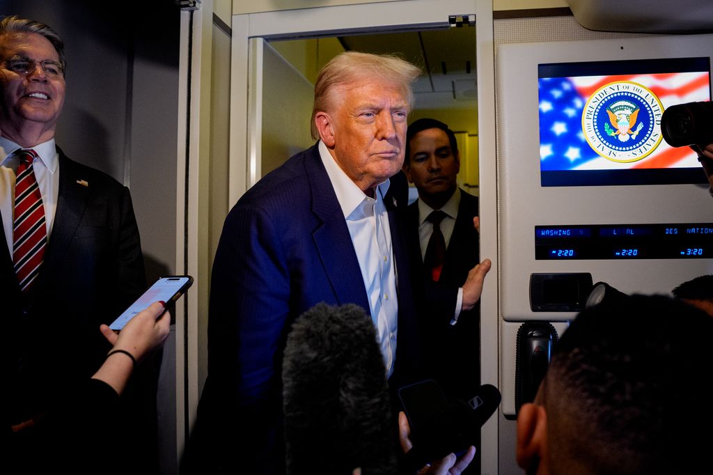 U.S. President Donald Trump, accompanied by U.S. Secretary of State Marco Rubio, (2nd R), U.S. Treasury Secretary Scott Bessent (L), and U.S. Trade Representative Jamieson Greer (R), speaks to members of the media aboard Air Force One on October 27, 2025, in flight
