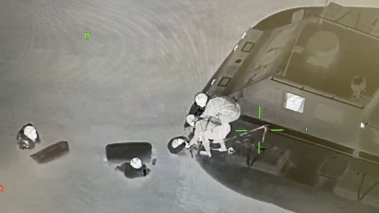 Fishermen cling to chilly bins after their boat sank in the Manukau Harbour. (Source: NZ Police)