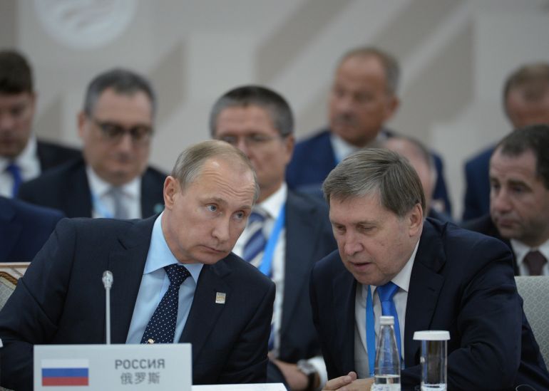 UFA, RUSSIA - JULY 10: In this handout image supplied by Host Photo Agency/RIA Novosti, President of the Russian Federation Vladimir Putin, left, and Presidential Aide Yury Ushakov during the signing of joint documents following the SCO Heads of State Council Meeting. during the BRICS/SCO Summits - Russia 2015 on July 10, 2015 in Ufa, Russia. (Photo by Host Photo Agency/Ria Novosti via Getty Images)