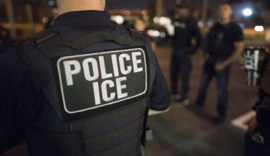 An ICE officer stands during an enforcement operation as fears of nearby immigration raids prompt some families to keep students home, contributing to falling attendance and heightened anxiety in schools. Courtesy of