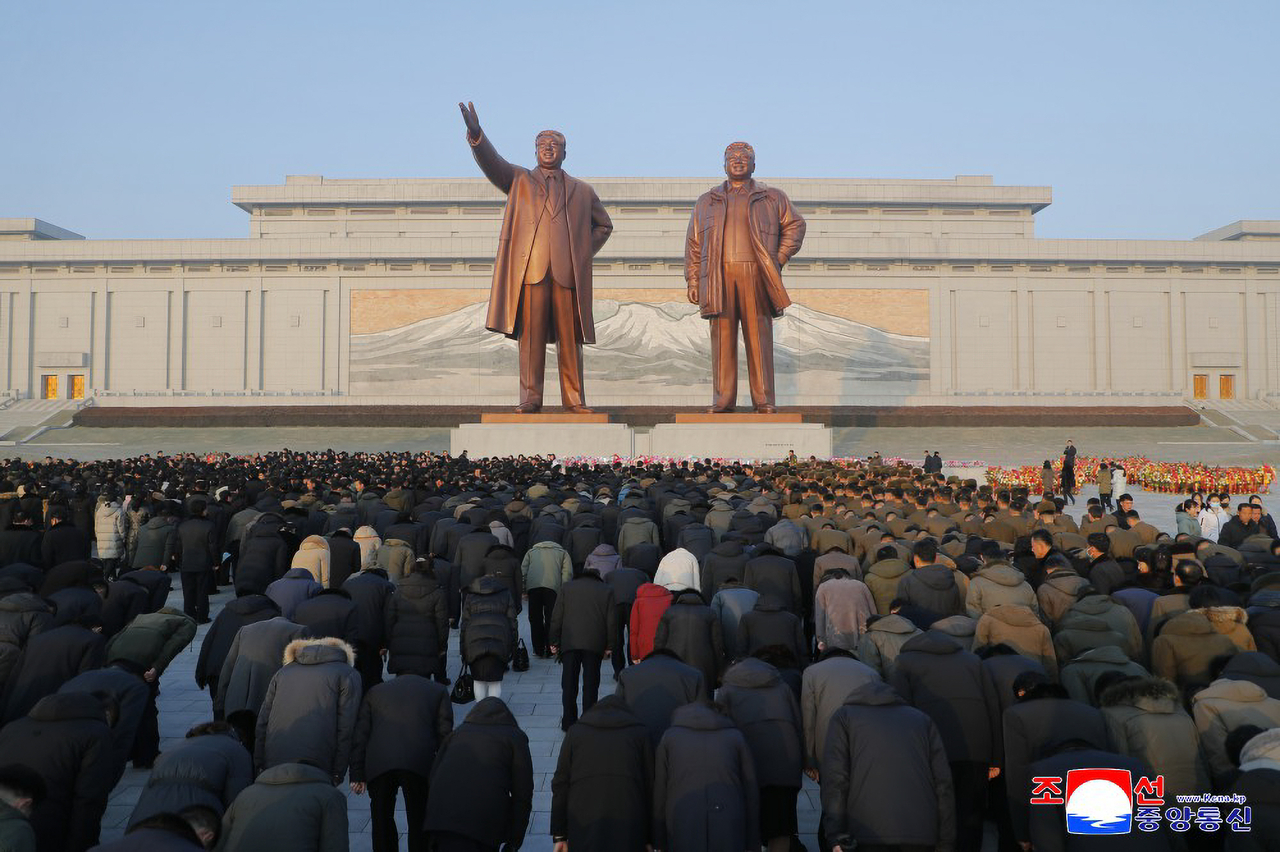 North Koreans bow before statues of Kim Il-sung and Kim Jong-il at Mansu Hill in Pyongyang as flower baskets and bouquets are laid nationwide to mark the 14th anniversary of former leader Kim Jong-il’s death, according to the Korean Central News Agency, Dec. 18. (KCNA)