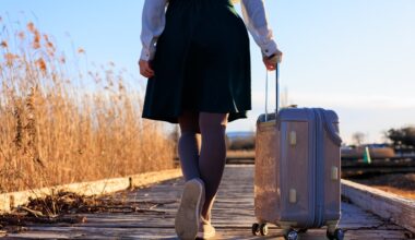 Woman walking down street with roller suitcase
