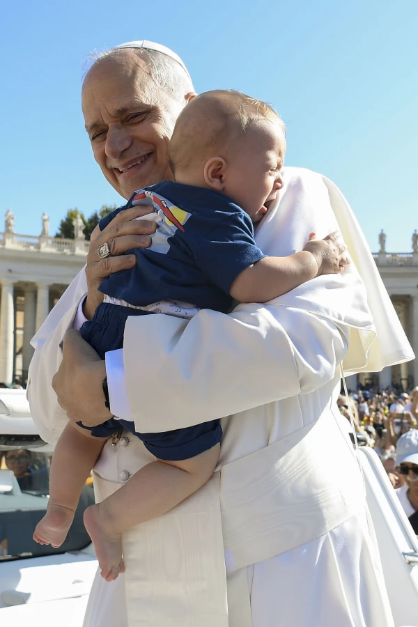 Pope Leo embraces a crying baby in St. Peter's Square on Sept. 6, 2025. Credit: Vatican Media
