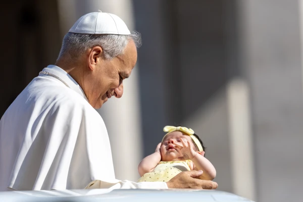 Pope Leo XIV blesses a baby during his Wednesday general audience on Aug. 6, 2025, in St. Peter’s Square at the Vatican. Credit: Daniel Ibañez/CNA