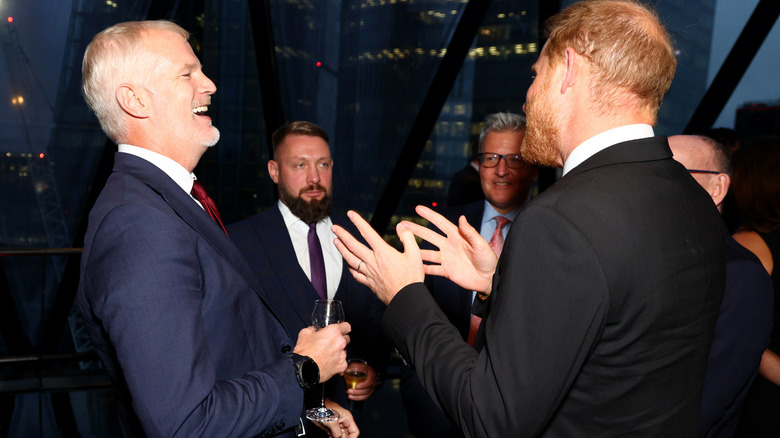 Prince Harry laughing with British government officials
