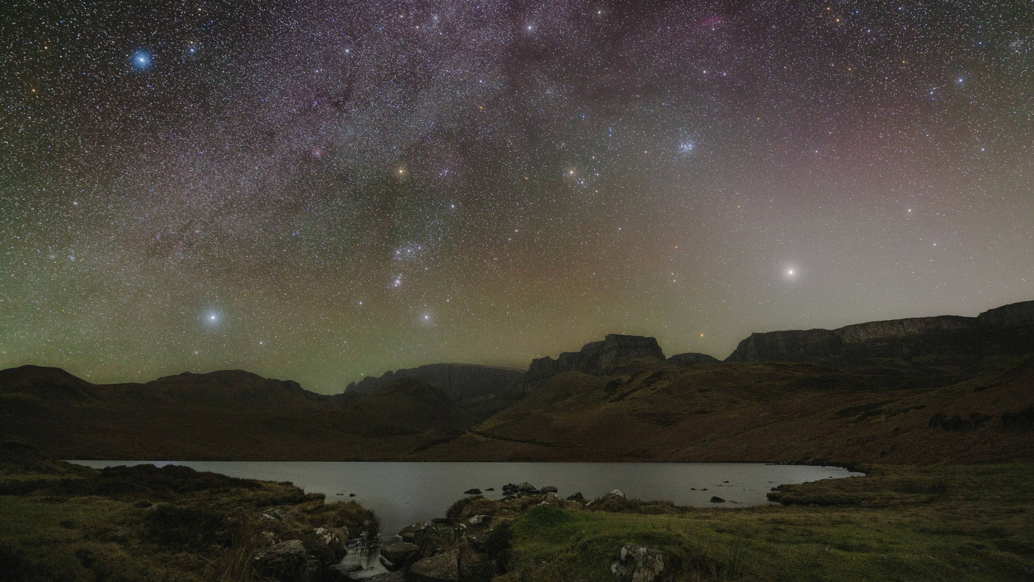 Mountains and a lake with the night sky.