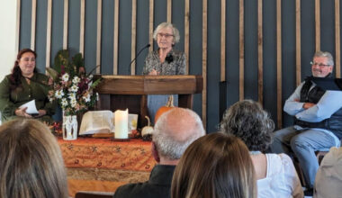Loretta Lapp, a charter member of Ridgeview Mennonite Church, shares during a rededication service Oct. 26. At left is Katelyn Robbins, pastor of Ridgeview. At right is John Denlinger, church member and former pastor. — Sarah Rohrer