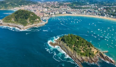 Aerial view of San Sebastián bay with turquoise water, Santa Clara Island and Donostia city.