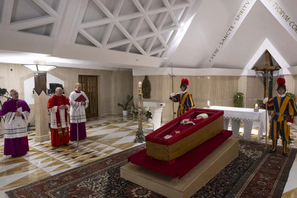 The body of Pope Francis lies in state at the Vatican's Domus Sanctae Marthae chapel, surrounded by Swiss Guards, cardinals, and Vatican officials paying their respects before his transfer to St. Peter's Basilica for public veneration, Monday, April 21, 2025. Credit: Vatican Media