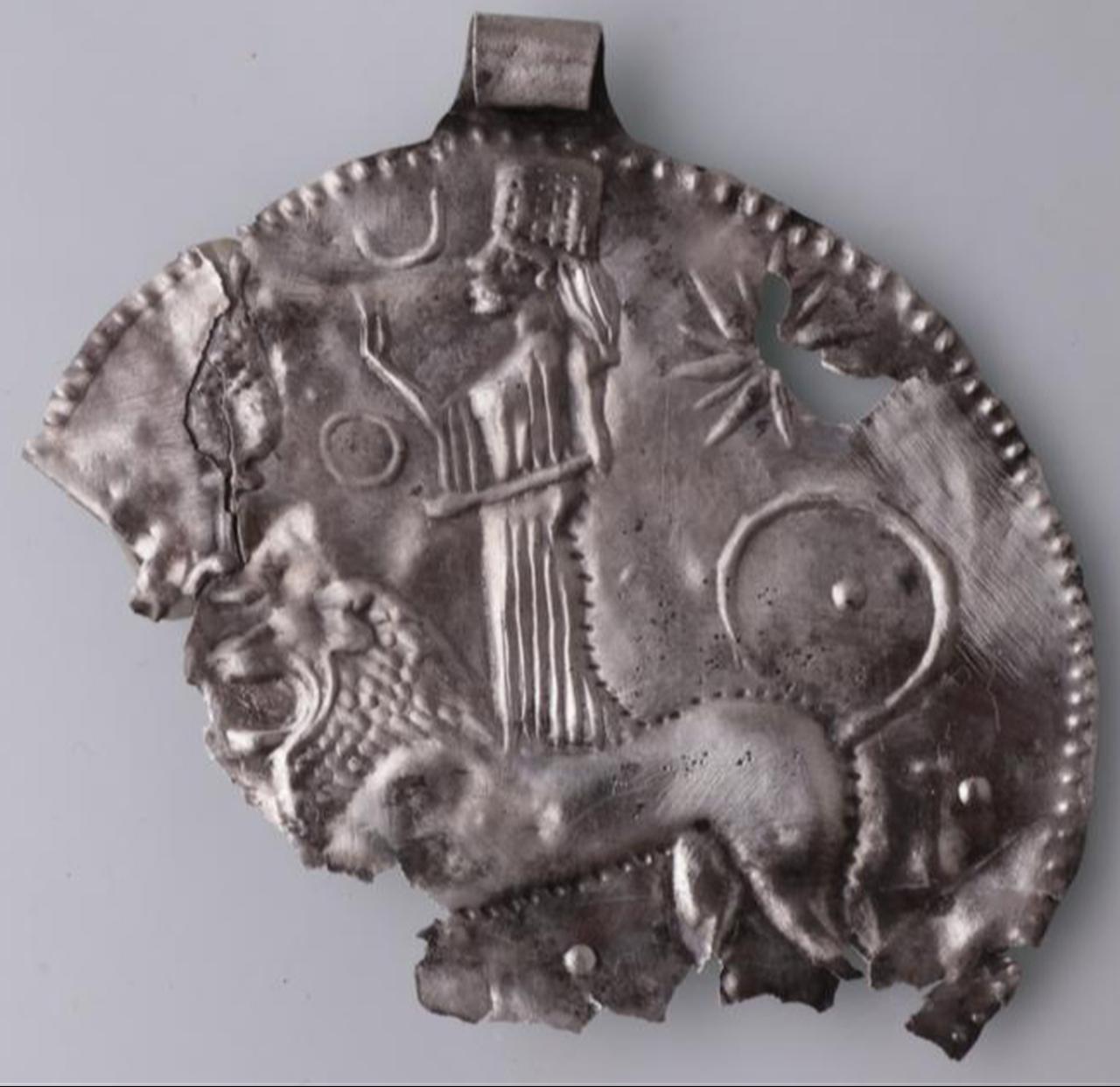 A silver necklace believed to depict the goddess Ishtar, featuring a lion figure and an eight-pointed star, is unearthed at the 2,200-year-old Amos ancient city in the Marmaris district of Mugla, Türkiye, Dec. 30, 2025. (AA Photo)