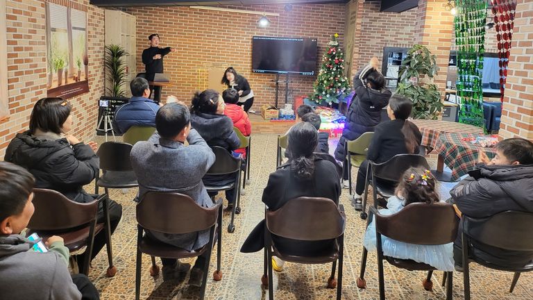 Il-yong Ju, seen standing at his laptop, in front the congregation at his church in Seoul, South Korea.
