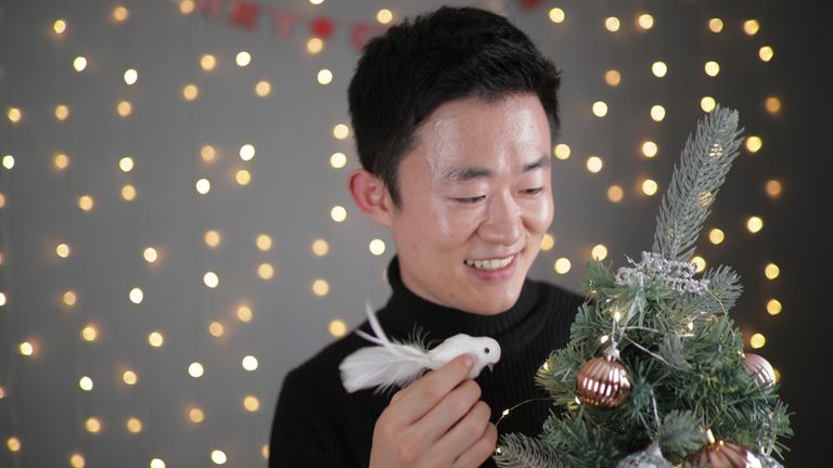 Il-yong Ju decorates a Christmas tree