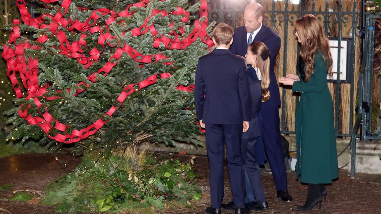 Royals hang loops of red paper bearing their handwritten names on a "Connection Tree". Pic: Reuters