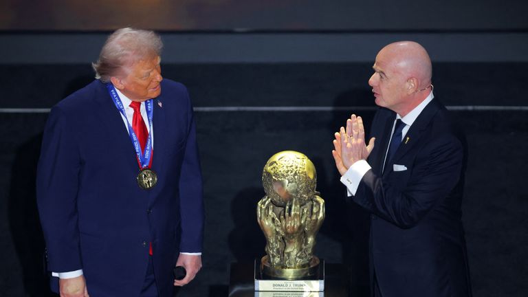 Soccer Football - FIFA World Cup 2026 - FIFA World Cup 2026 Draw - John F. Kennedy Center for the Performing Arts, Washington, D.C., U.S. - December 5, 2025 U.S. President Donald Trump wears his medal as he is awarded the FIFA Peace Prize Pool via RE
