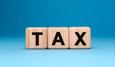 TAX word cube on a blue background.