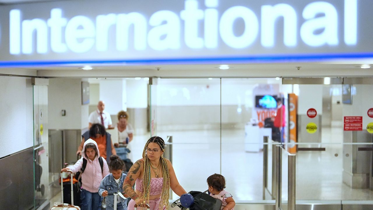 Passengers arriving on international flights walk out into the international arrivals area at Miami International Airport, Monday, June 9, 2025, in Miami. (AP Photo/Rebecca Blackwell, File)