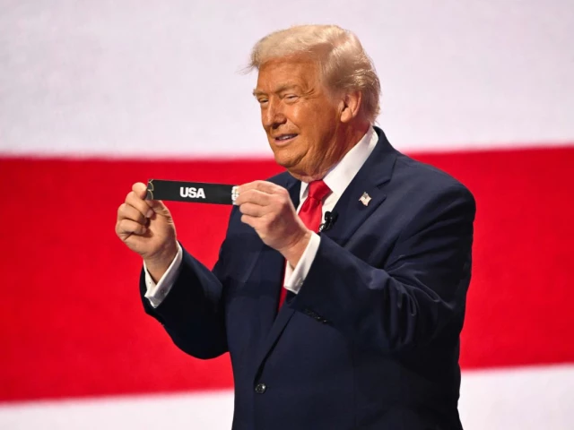 us president donald trump shows the card reading usa during the draw for the 2026 fifa football world cup taking place in the us canada and mexico at the kennedy center in washington dc on december 5 2025 photo afp