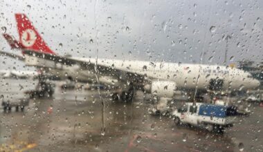 File photo shows a blurred view of a Turkish Airlines aircraft parked at the gate through an airport window covered with raindrops, accessed on Feb. 5, 2025 (Adobe Stock Photo)