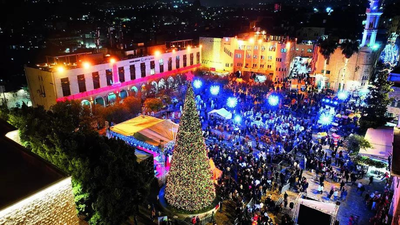 A drone view of the lighting up of a Christmas tree in Manger Square outside the Church of the Nativity in Bethlehem in the Israeli-occupied West Bank Israel & Hamas close to 2nd phase of truce: Bibi