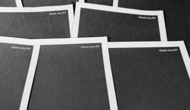 A pile of papers, which have been completely redacted with black boxes.