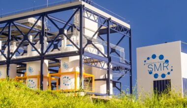 A small modular reactor facility under a clear blue sky.