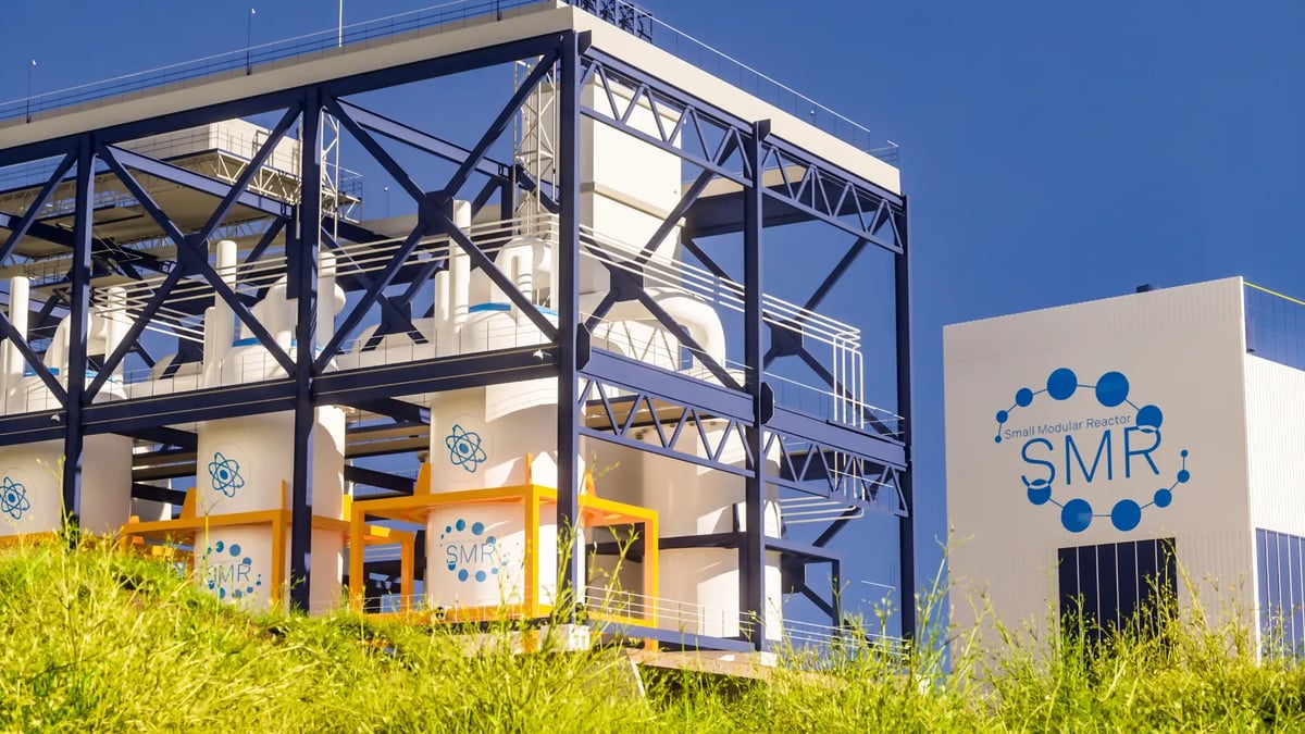 A small modular reactor facility under a clear blue sky.