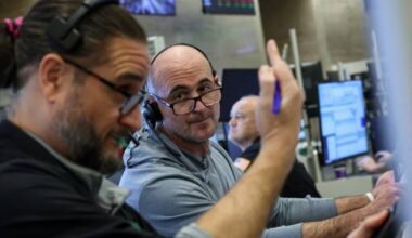 Wall Street closes lower as investors position for busy week