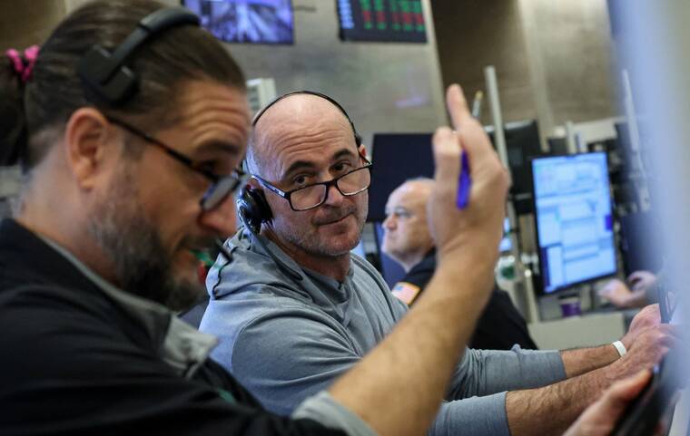 Wall Street closes lower as investors position for busy week