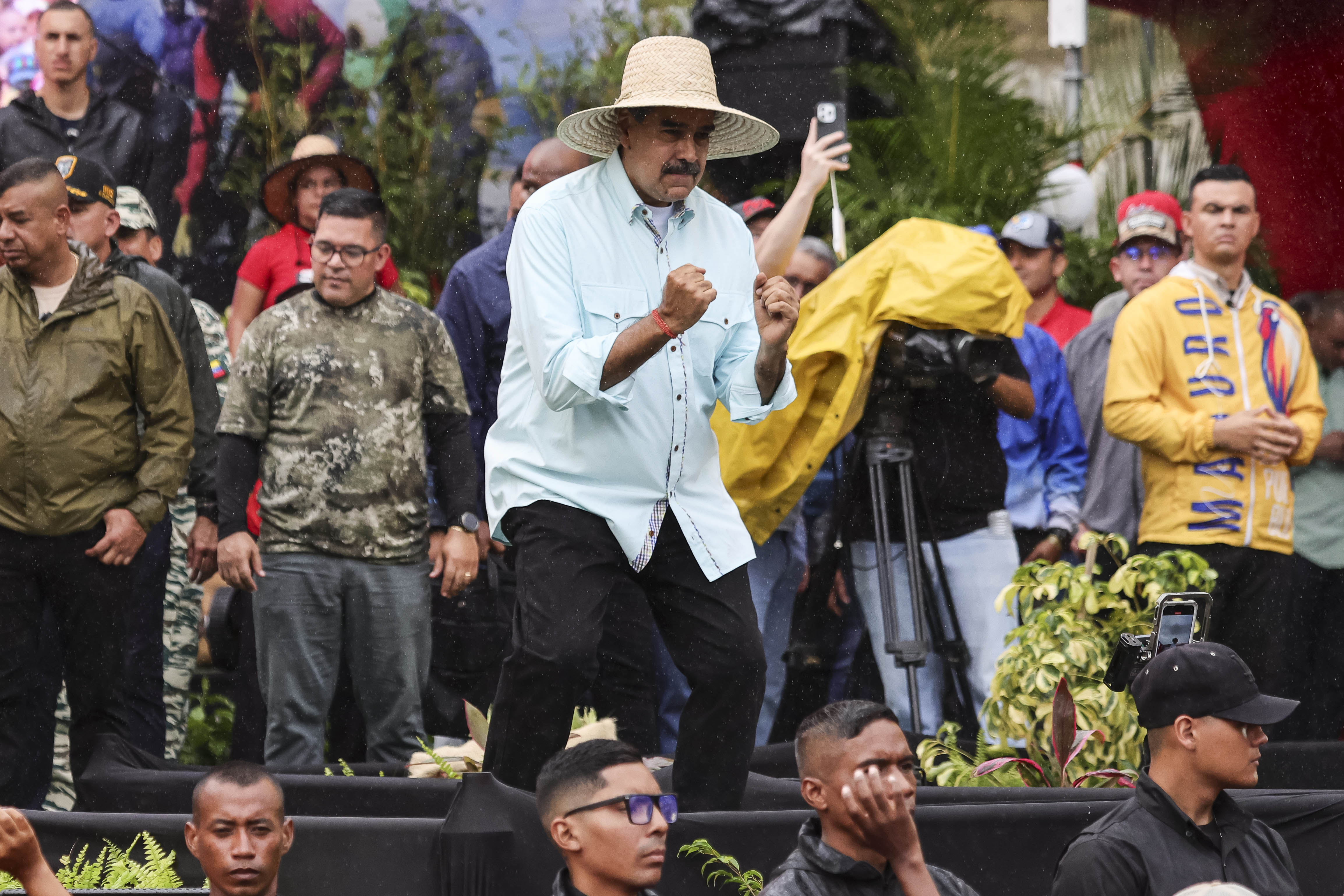 Venezuelan President Nicolas Maduro dances on stage.