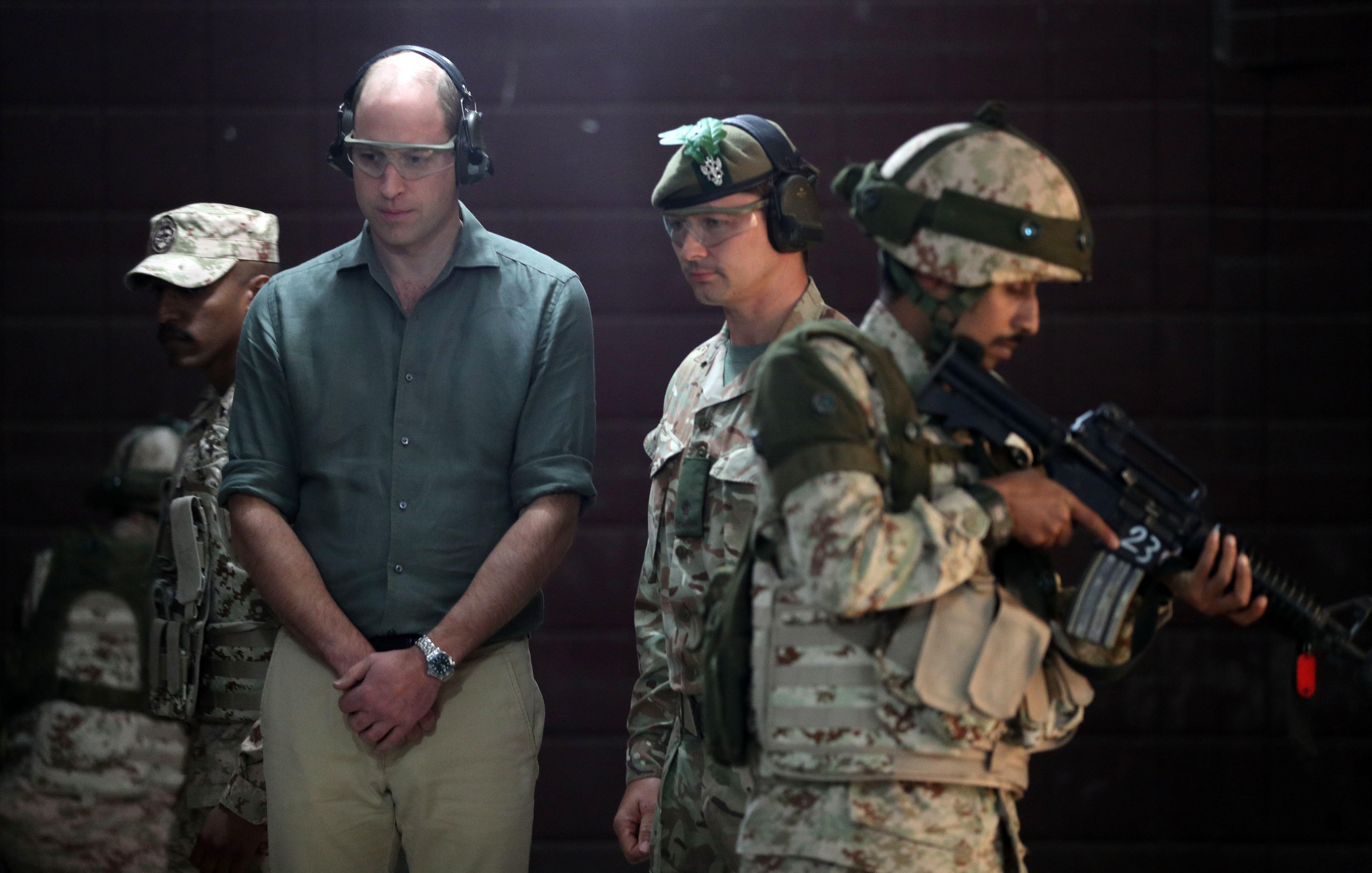 Prince William, Duke of Cambridge, observing military training alongside Kuwaiti and British soldiers during Exercise Desert Warrior.