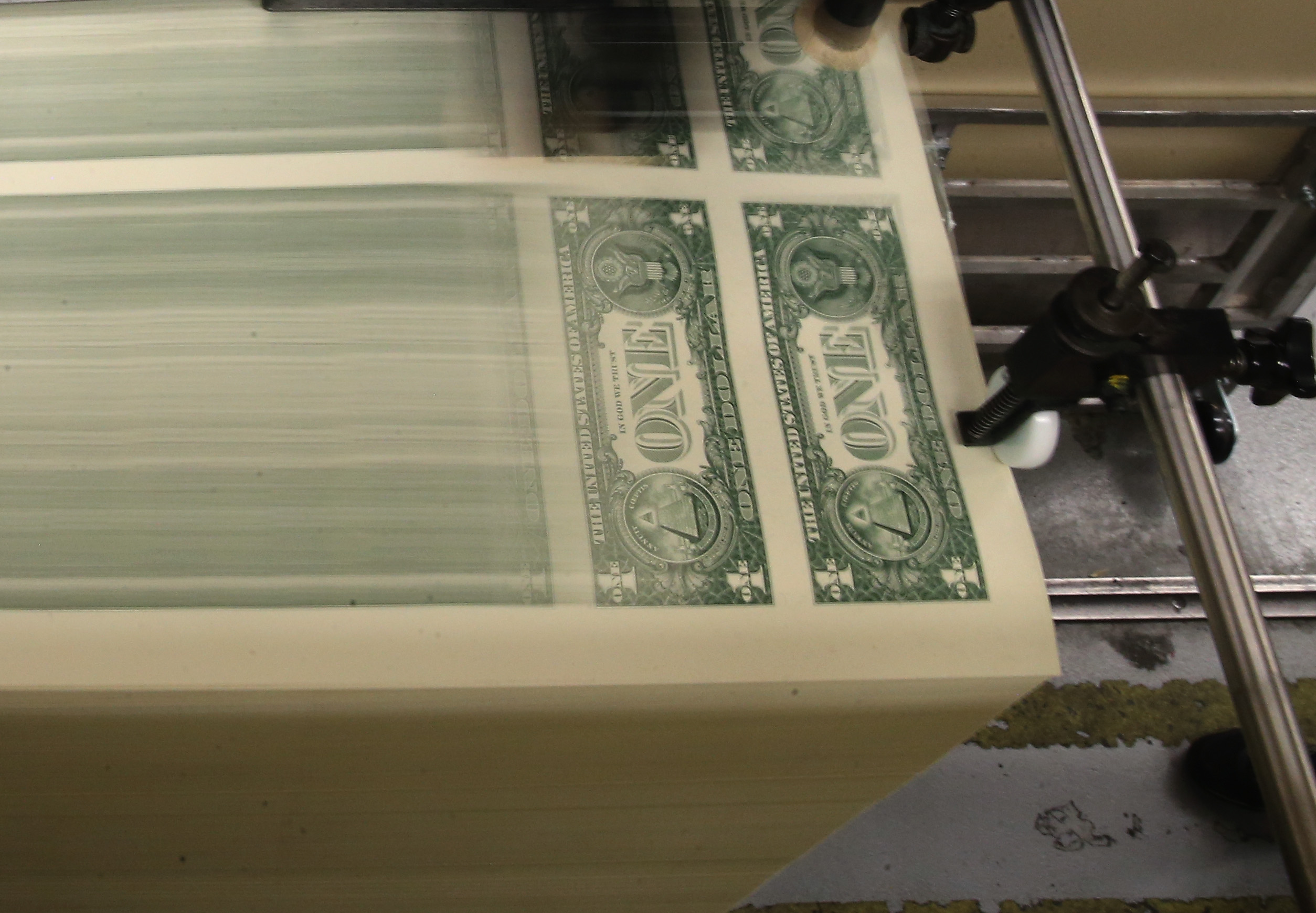 Sheets of dollar bills are printed in a press at the Bureau of Engraving and Printing.